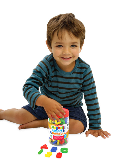 little boy holding plactic jar with 80 pieces of magnectic letters and numbers