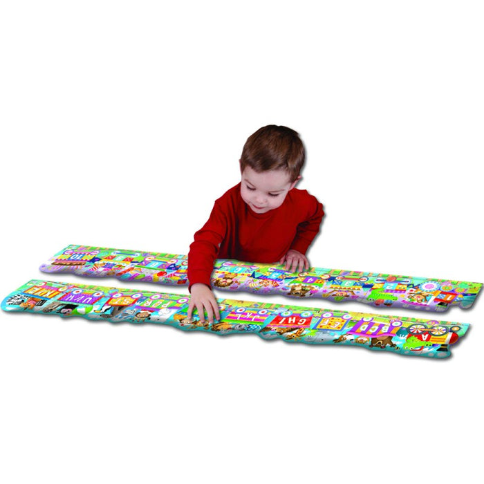 boy with both giant floor puzzle complete